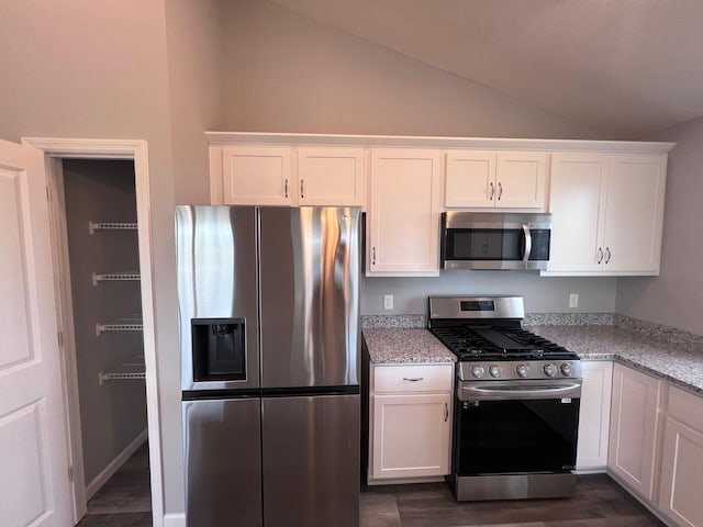 2488 Jacamar Ave NE, Saint Michael, MN 55376 - kitchen with stainless steel appliances, white cabinets, light stone counters, dark wood finished floors, and high vaulted ceiling