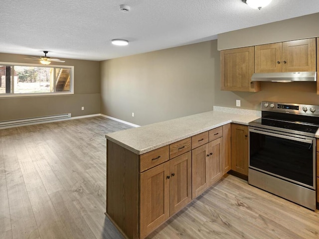 26161 8th St W, Zimmerman, MN 55398 - kitchen with stainless steel electric range oven, baseboard heating, under cabinet range hood, light wood-style flooring, and a textured ceiling