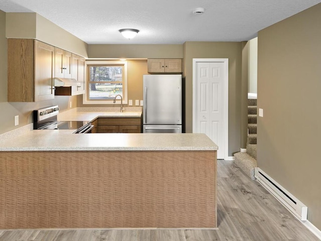 26161 8th St W, Zimmerman, MN 55398 - kitchen featuring stainless steel appliances, a baseboard heating unit, light countertops, a peninsula, and light wood-style floors
