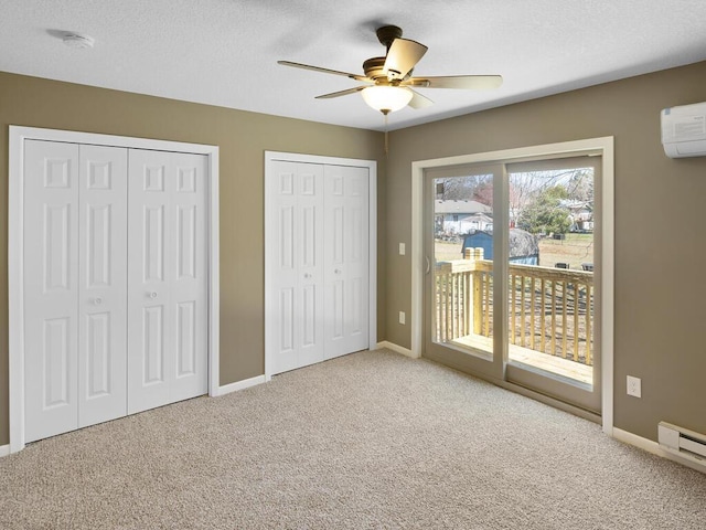 26161 8th St W, Zimmerman, MN 55398 - unfurnished bedroom featuring access to outside, carpet floors, multiple closets, a baseboard heating unit, and an AC wall unit