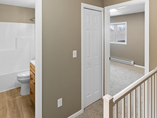 26161 8th St W, Zimmerman, MN 55398 - bathroom with a baseboard heating unit, vanity, shower / bathtub combination, and wood finished floors