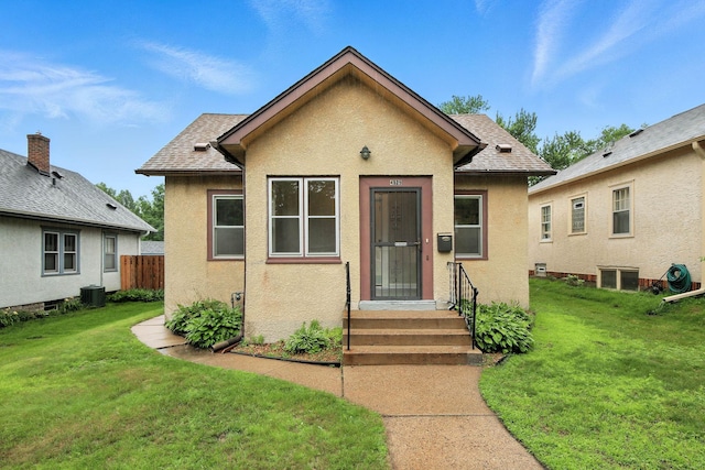 4529 17th Ave S, Minneapolis, MN 55407 - bungalow with stucco siding, a front lawn, and roof with shingles