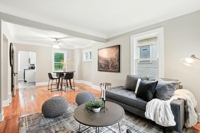 4529 17th Ave S, Minneapolis, MN 55407 - living room featuring light wood-type flooring, arched walkways, and a ceiling fan