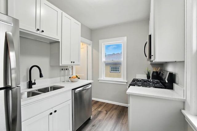 4529 17th Ave S, Minneapolis, MN 55407 - kitchen with stainless steel appliances, dark wood-style floors, and white cabinetry