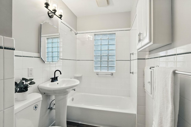 4529 17th Ave S, Minneapolis, MN 55407 - bathroom featuring tile walls, shower / bathtub combination, and healthy amount of natural light