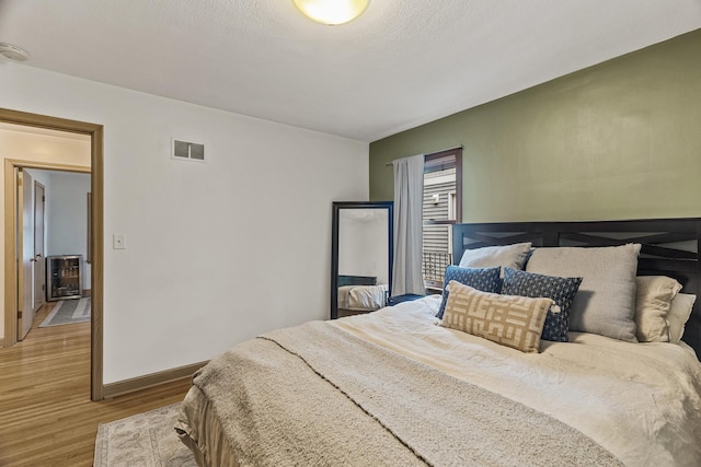 5524 34th Ave S, Minneapolis, MN 55417 - bedroom featuring wood finished floors and heating unit