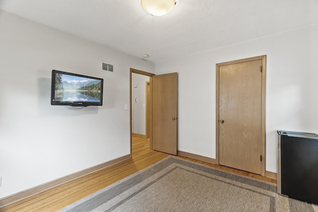 5524 34th Ave S, Minneapolis, MN 55417 - unfurnished bedroom featuring wood finished floors and baseboards