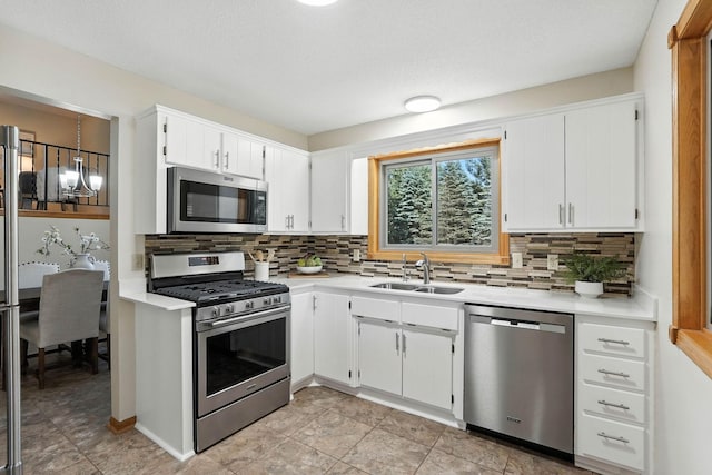 14226 310th Ave, Princeton, MN 55371 - kitchen featuring stainless steel appliances, light countertops, decorative backsplash, and white cabinets