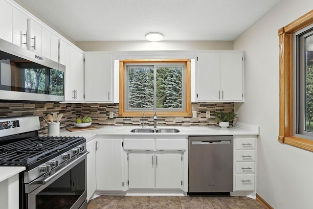14226 310th Ave, Princeton, MN 55371 - kitchen with appliances with stainless steel finishes, backsplash, light countertops, and white cabinetry