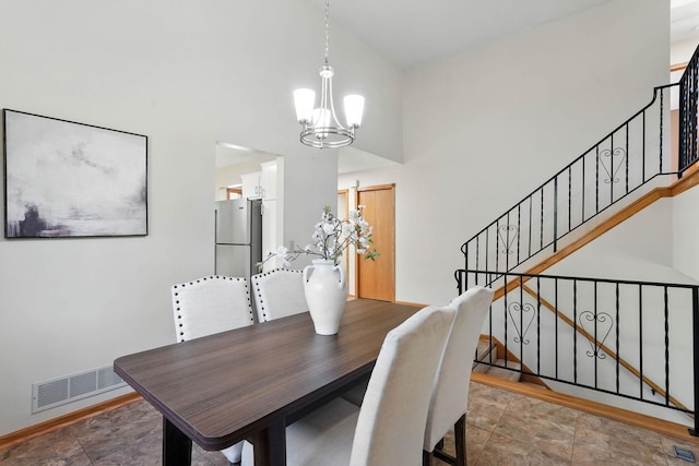 14226 310th Ave, Princeton, MN 55371 - dining space featuring a chandelier, stairs, a high ceiling, and stone finish flooring