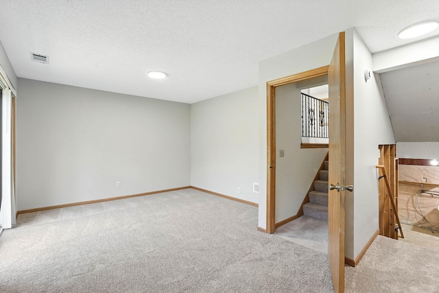 14226 310th Ave, Princeton, MN 55371 - basement featuring light carpet, stairs, and a textured ceiling
