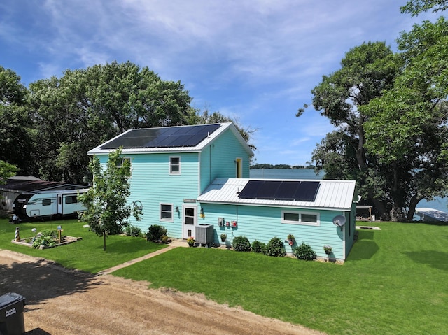 34 Shady Rest Rd, Lake Sarah Twp, MN 56132 - view of front of property featuring roof mounted solar panels, a metal roof, a front lawn, and dirt driveway