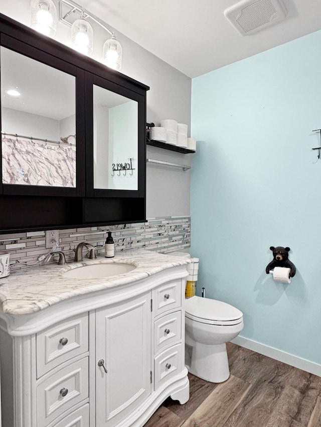 34 Shady Rest Rd, Lake Sarah Twp, MN 56132 - full bath featuring vanity, wood finished floors, and backsplash