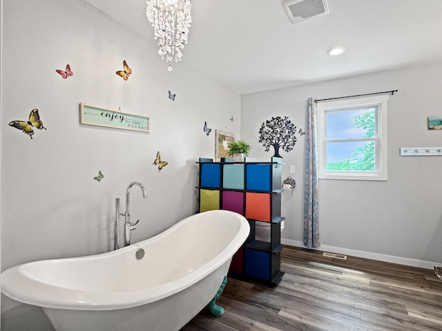 34 Shady Rest Rd, Lake Sarah Twp, MN 56132 - bathroom with wood finished floors, a chandelier, a freestanding bath, and recessed lighting