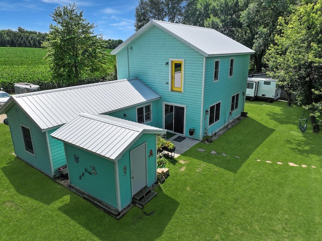 34 Shady Rest Rd, Lake Sarah Twp, MN 56132 - back of property with a metal roof, a lawn, an outdoor structure, and a standing seam roof