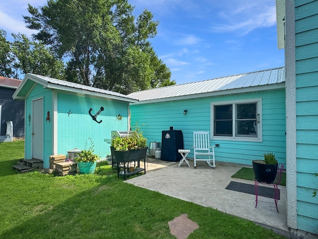 34 Shady Rest Rd, Lake Sarah Twp, MN 56132 - back of house featuring a lawn, a patio, an outbuilding, and a metal roof