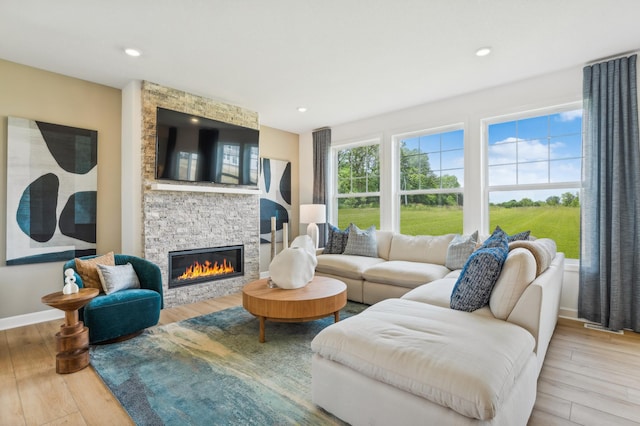 7945 Jade Ln, Victoria, MN 55386 - living area featuring a fireplace, wood finished floors, and recessed lighting