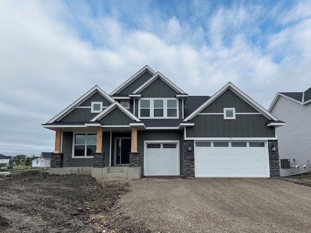 7945 Jade Ln, Victoria, MN 55386 - craftsman-style home featuring board and batten siding, stone siding, driveway, covered porch, and an attached garage