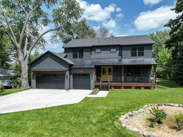 625 Ivy Falls Ave, Mendota Heights, MN 55118 - view of front of property featuring a metal roof, a standing seam roof, concrete driveway, a front yard, and a porch