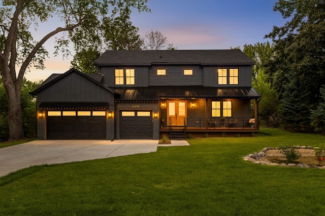 625 Ivy Falls Ave, Mendota Heights, MN 55118 - view of front facade with driveway, a porch, a yard, an attached garage, and a metal roof