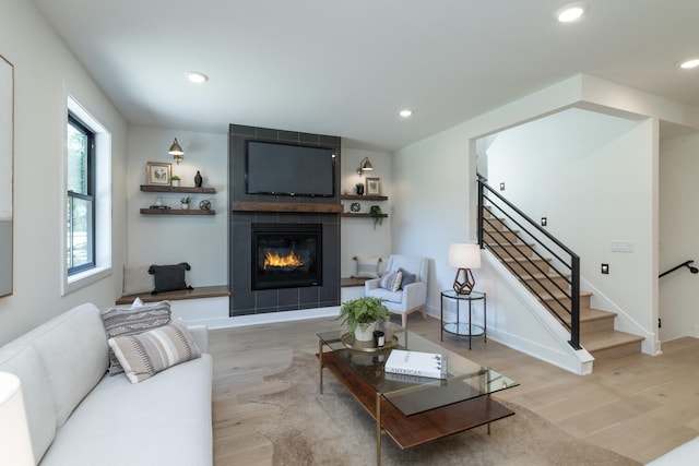 625 Ivy Falls Ave, Mendota Heights, MN 55118 - living room featuring wood finished floors, stairway, a tiled fireplace, and recessed lighting