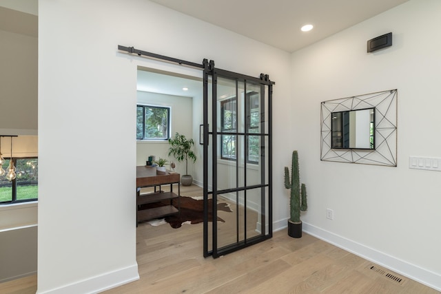 625 Ivy Falls Ave, Mendota Heights, MN 55118 - entryway featuring light wood-type flooring, a barn door, and recessed lighting