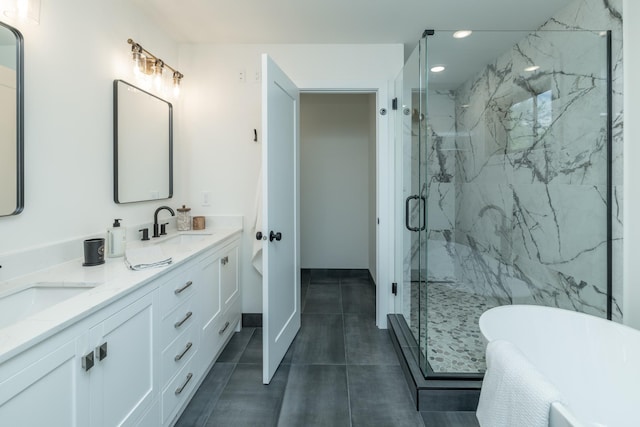 625 Ivy Falls Ave, Mendota Heights, MN 55118 - bathroom featuring double vanity, a freestanding tub, a marble finish shower, recessed lighting, and tile patterned floors