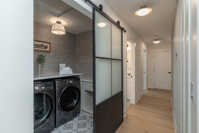 625 Ivy Falls Ave, Mendota Heights, MN 55118 - laundry area with independent washer and dryer, a barn door, and light wood-style floors
