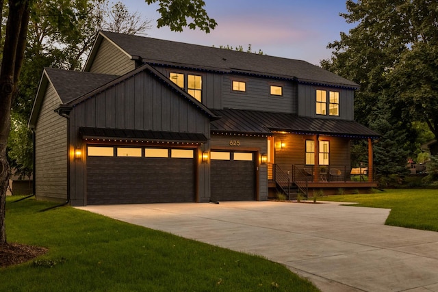 625 Ivy Falls Ave, Mendota Heights, MN 55118 - modern inspired farmhouse with a porch, concrete driveway, a front lawn, board and batten siding, and a standing seam roof