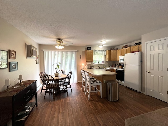 15965 Red Sand Cir, Brainerd, MN 56401 - kitchen with white appliances, a peninsula, a breakfast bar area, dark wood-type flooring, and a wall mounted air conditioner