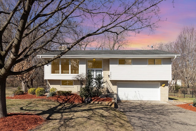 2805 Regent Ave N, Golden Valley, MN 55422 - raised ranch featuring brick siding, driveway, and an attached garage