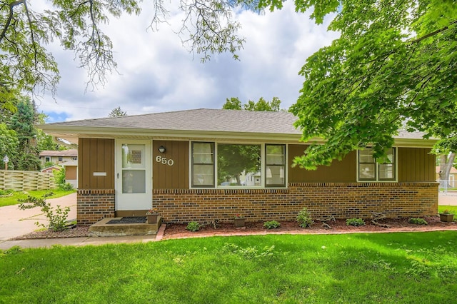 650 58th Ave NE, Fridley, MN 55432 - view of front of house with brick siding, a front lawn, board and batten siding, and a shingled roof