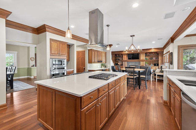 7471 260th St, Wyoming, MN 55092 - kitchen with island range hood, appliances with stainless steel finishes, brown cabinets, open floor plan, and dark wood-style floors