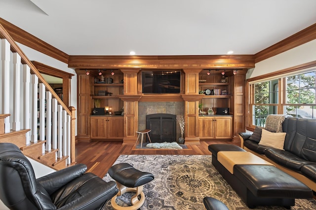 7471 260th St, Wyoming, MN 55092 - living room with ornamental molding, dark wood finished floors, a tiled fireplace, stairs, and built in features