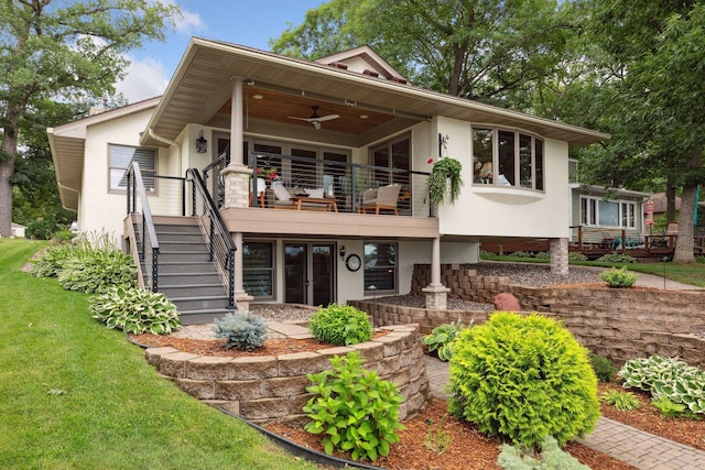 9525 Shore Trl N, Forest Lake, MN 55025 - rear view of house featuring stucco siding, a ceiling fan, french doors, a lawn, and stairway