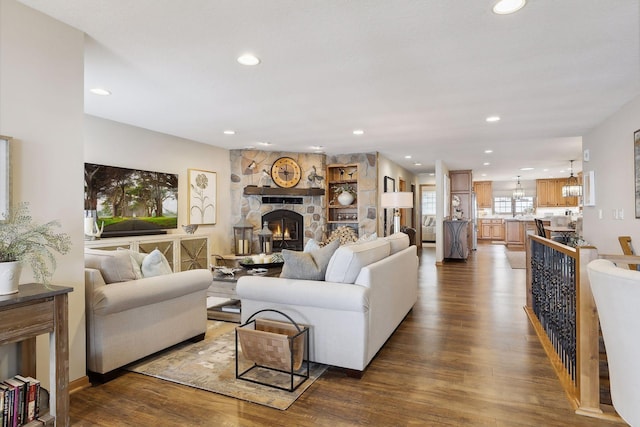 9525 Shore Trl N, Forest Lake, MN 55025 - living area with dark wood-style floors, recessed lighting, and a stone fireplace