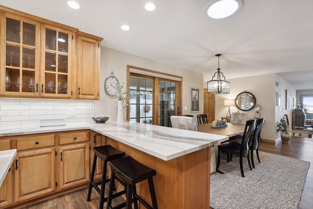 9525 Shore Trl N, Forest Lake, MN 55025 - kitchen featuring a kitchen breakfast bar, dark wood-style floors, decorative backsplash, plenty of natural light, and recessed lighting