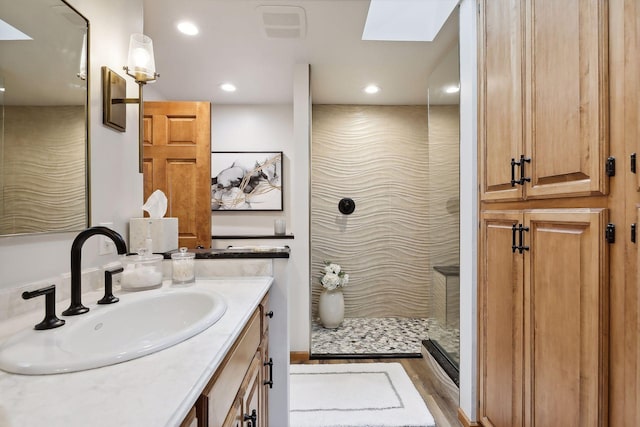 9525 Shore Trl N, Forest Lake, MN 55025 - full bathroom featuring a skylight, vanity, walk in shower, and recessed lighting
