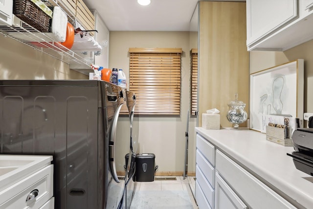 9525 Shore Trl N, Forest Lake, MN 55025 - laundry room with cabinet space, light tile patterned flooring, and washing machine and dryer