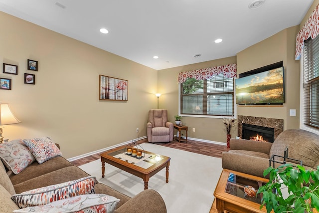 15618 Emerald Dr N Unit 2, Hugo, MN 55038 - living room featuring wood finished floors, plenty of natural light, a high end fireplace, and recessed lighting