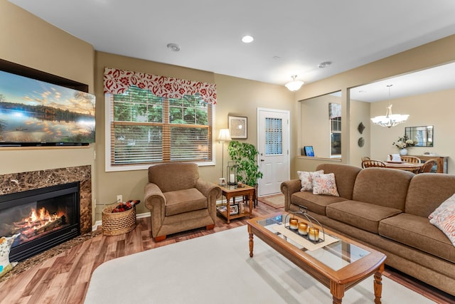 15618 Emerald Dr N Unit 2, Hugo, MN 55038 - living area with wood finished floors, a chandelier, a fireplace, and recessed lighting