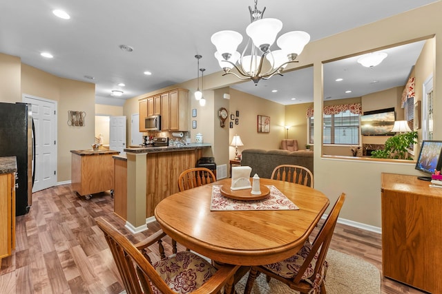 15618 Emerald Dr N Unit 2, Hugo, MN 55038 - dining area with light wood-style flooring, a chandelier, and recessed lighting