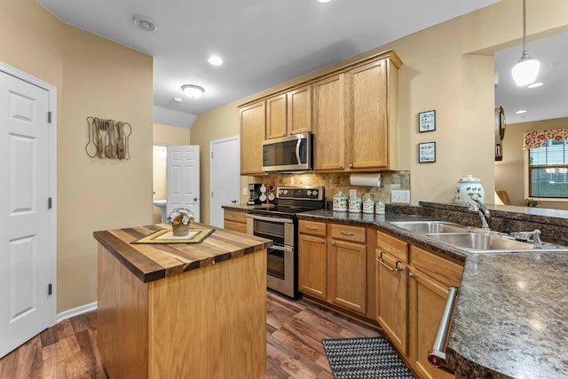 15618 Emerald Dr N Unit 2, Hugo, MN 55038 - kitchen with stainless steel appliances, wood counters, dark wood-style floors, a center island, and decorative backsplash