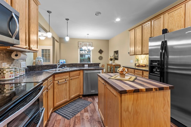 15618 Emerald Dr N Unit 2, Hugo, MN 55038 - kitchen with butcher block counters, appliances with stainless steel finishes, dark wood-type flooring, backsplash, and recessed lighting