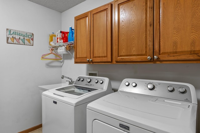 15618 Emerald Dr N Unit 2, Hugo, MN 55038 - washroom with washer and dryer, cabinet space, and a textured ceiling