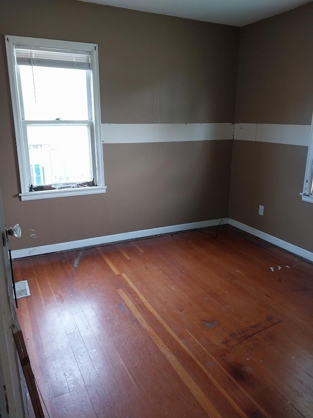 206 20th St S, Benson, MN 56215 - empty room featuring wood-type flooring and baseboards