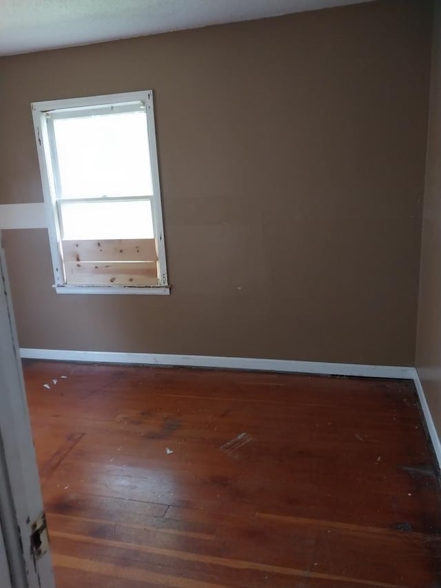 206 20th St S, Benson, MN 56215 - empty room featuring wood-type flooring and baseboards