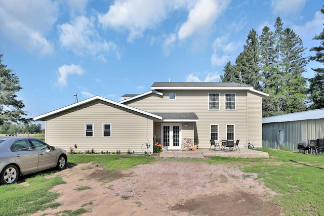 75309 Twin Oaks Rd, Bremen Twp, MN 55735 - back of house featuring french doors, a lawn, a patio area, and a shingled roof