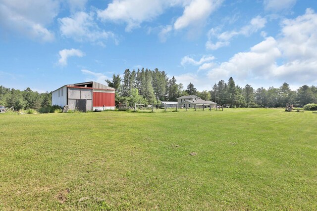 75309 Twin Oaks Rd, Bremen Twp, MN 55735 - view of grassy yard with a pole building and an outbuilding