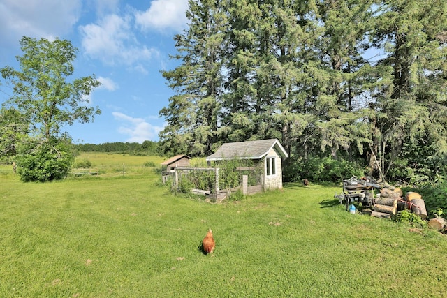 75309 Twin Oaks Rd, Bremen Twp, MN 55735 - view of grassy yard featuring a garden and an outdoor structure